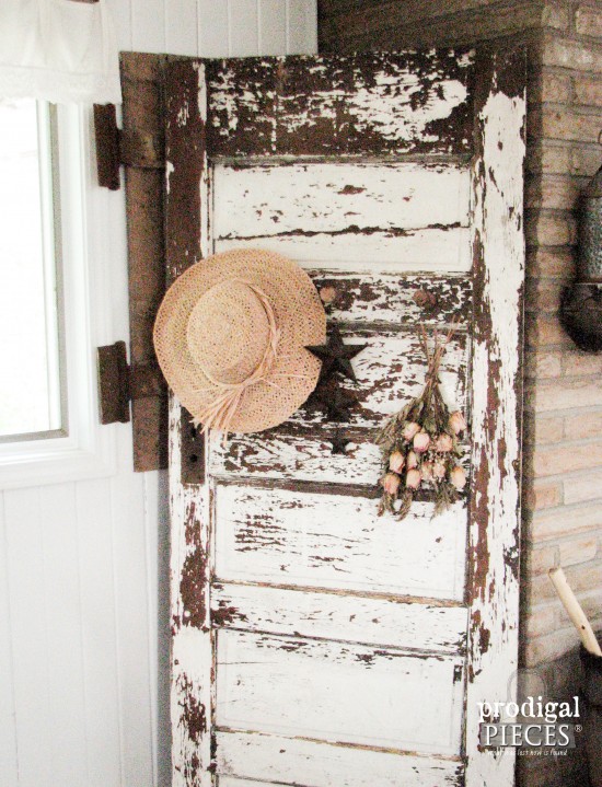 Antique chippy white door becomes functional decor with the addition of barn beam pegs by Prodigal Pieces | prodigalpieces.com
