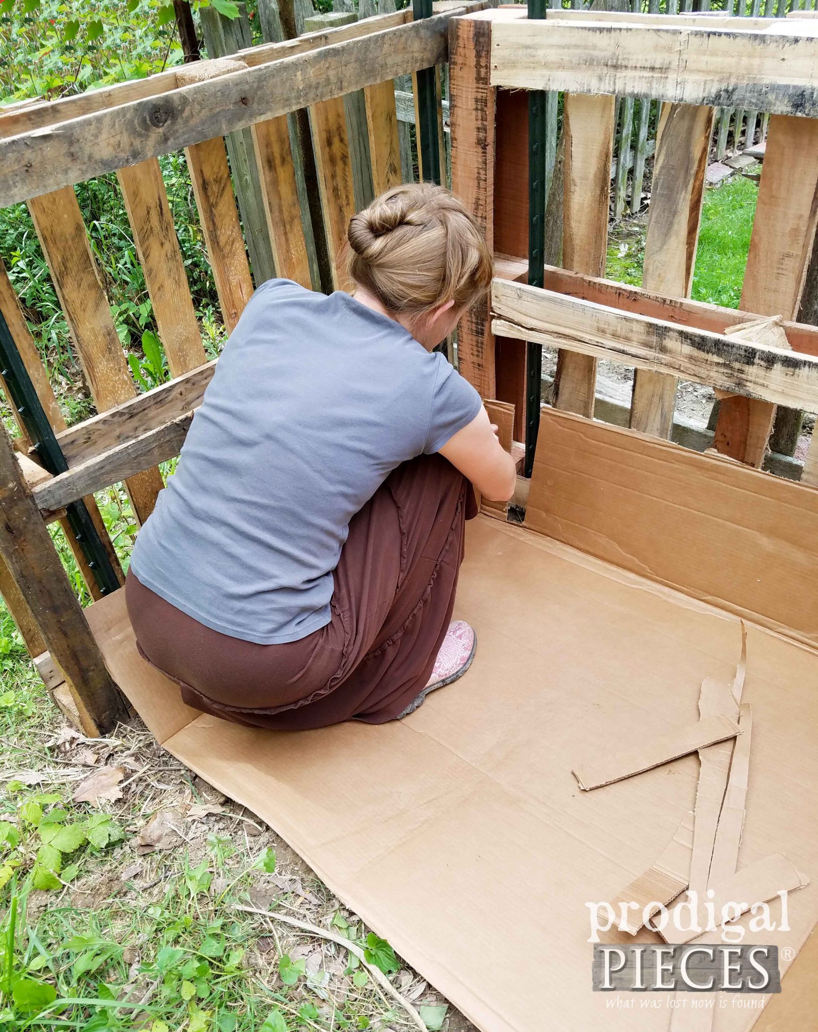Layering Cardboard in Pallet Compost Bin by Prodigal Pieces | prodigalpieces.com