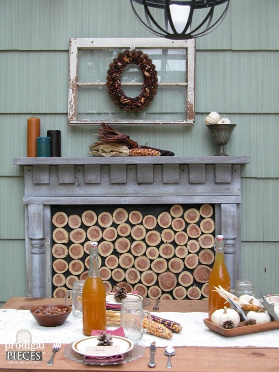This DIY patio design features a rustic and repurposed touches with a harvest table, faux fireplace, and curtains for privacy. All completed by one couple on a budget by Prodigal Pieces www.prodigalpieces.com #prodigalpieces