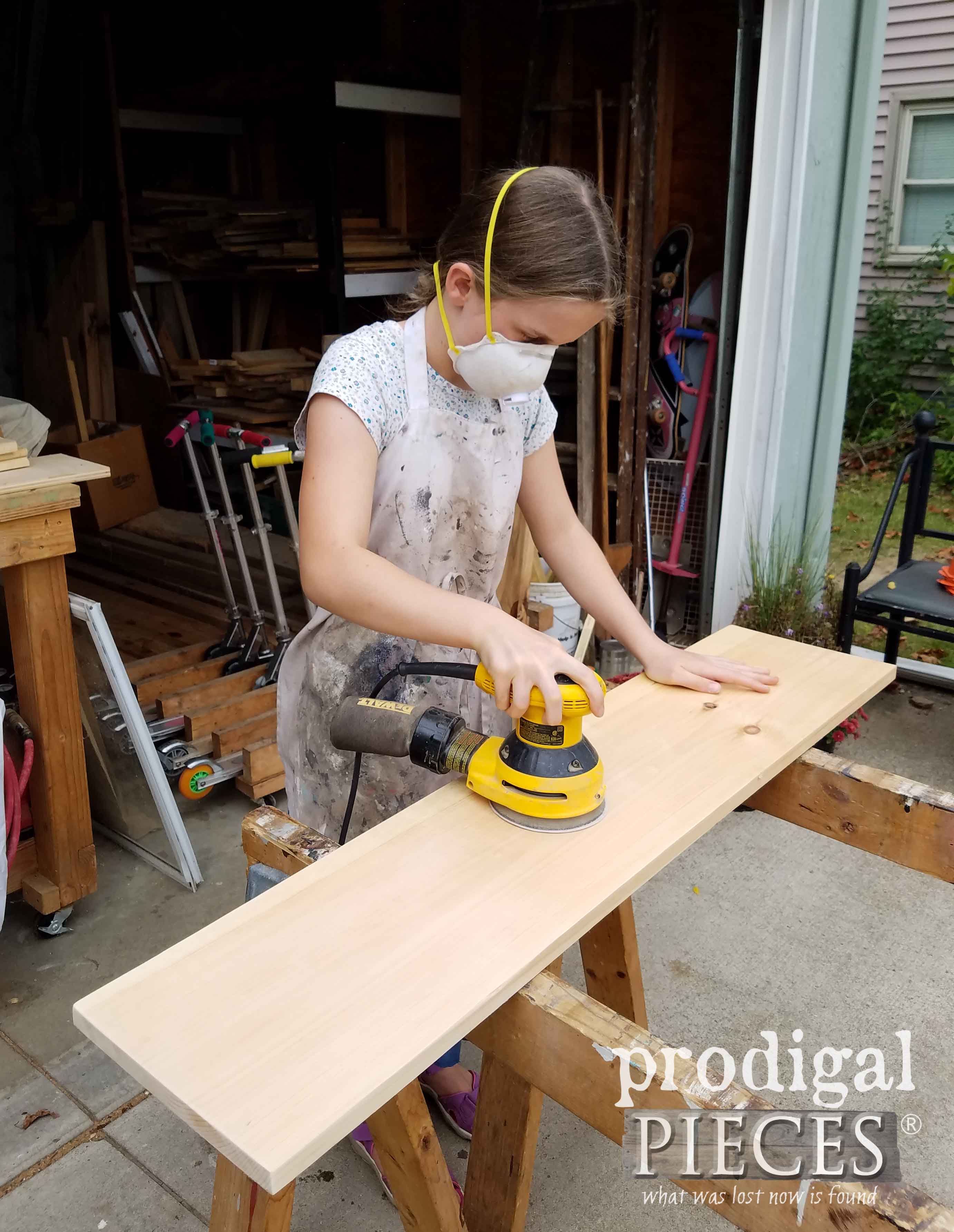 Pre-Teen Girl Sanding Wood Board | prodigalpieces.com