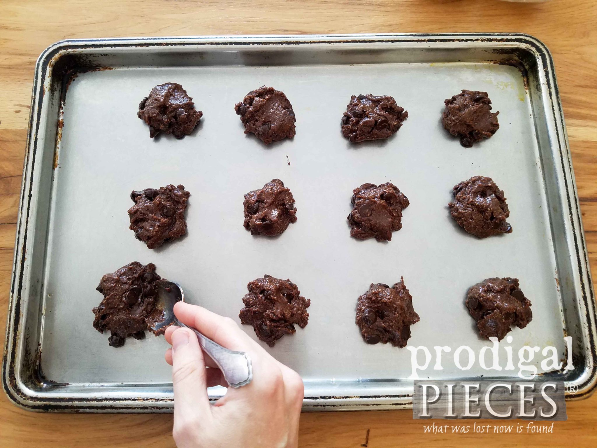 Placing flourless chocolate fudge cookies on baking sheet | prodigalpieces.com