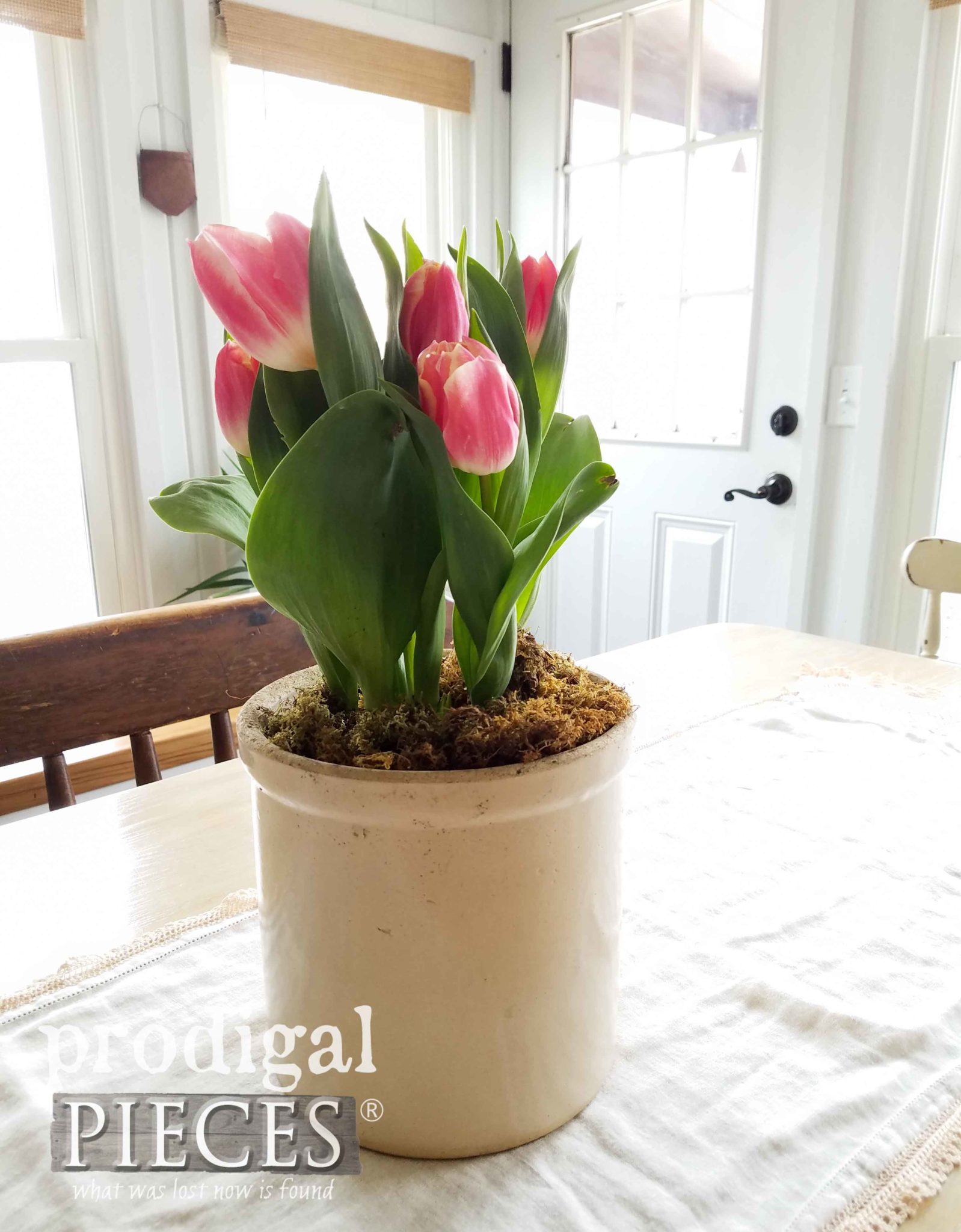 Antique Crock full of Tulip Blooms on Farmhouse Table by Larissa of Prodigal Pieces | prodigalpieces.com