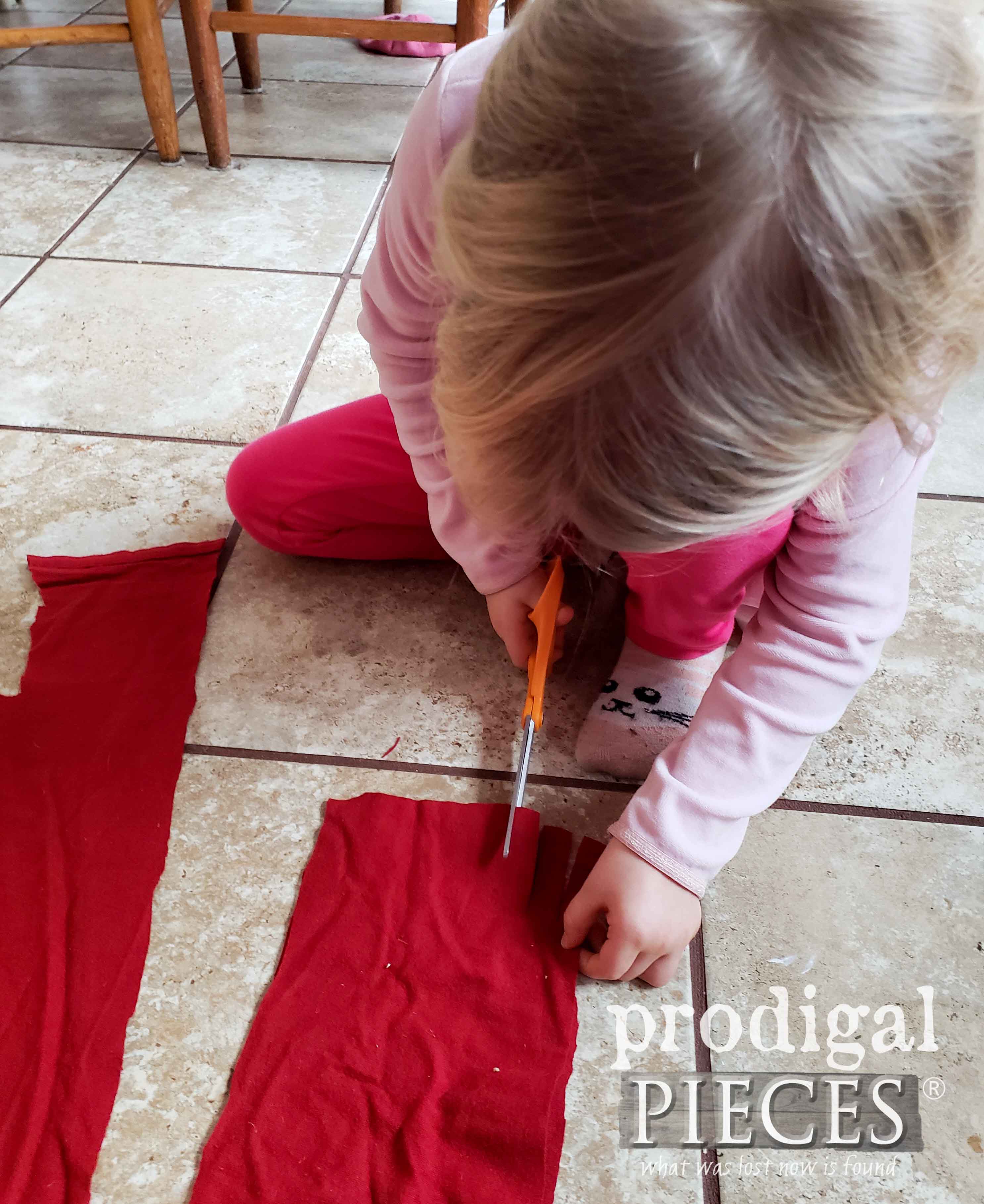 Cutting Red Flannel Sheet for Snowman Scarf | prodigalpieces.com