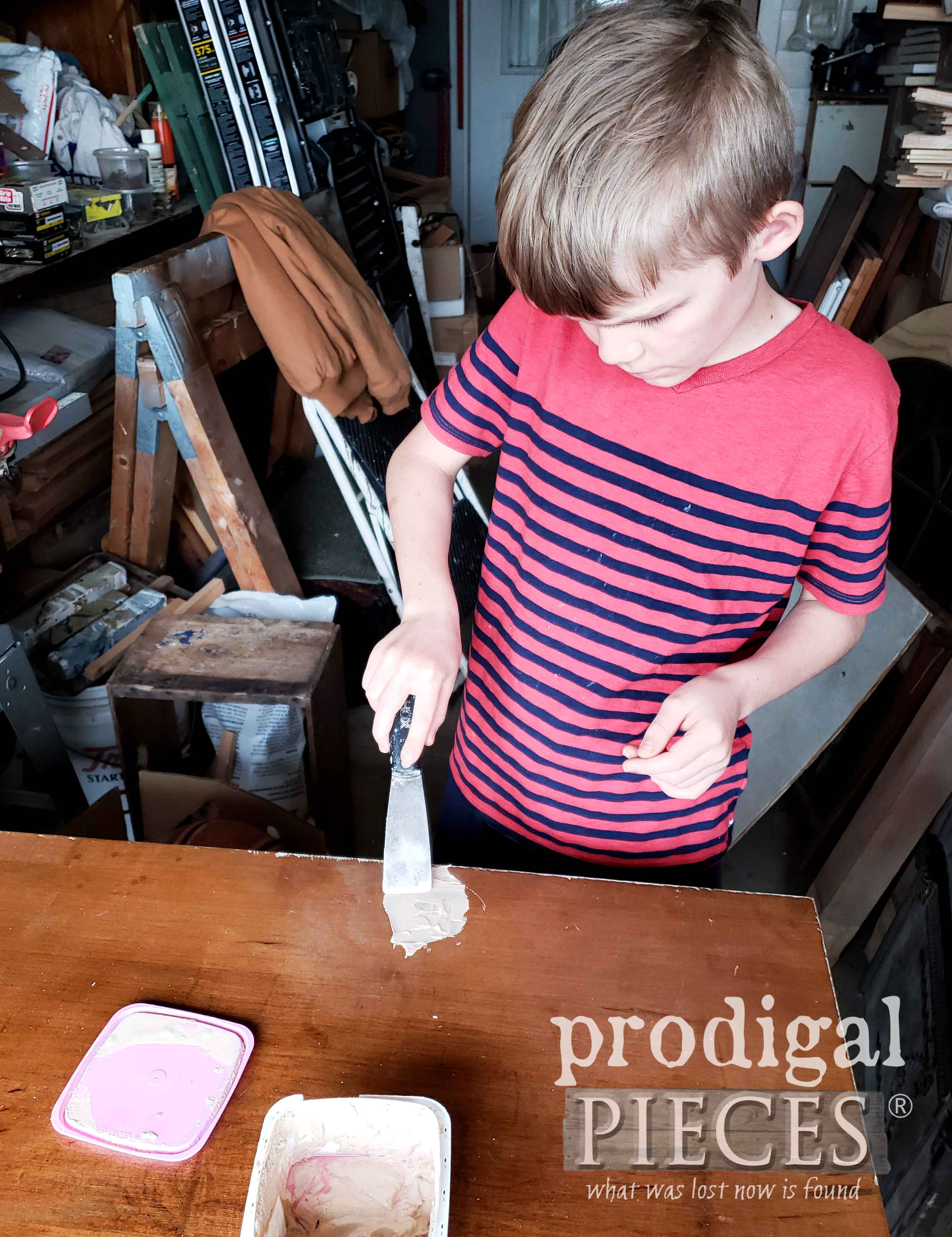 Boy Repairing Desk Top with Wood Filler | prodigalpieces.com