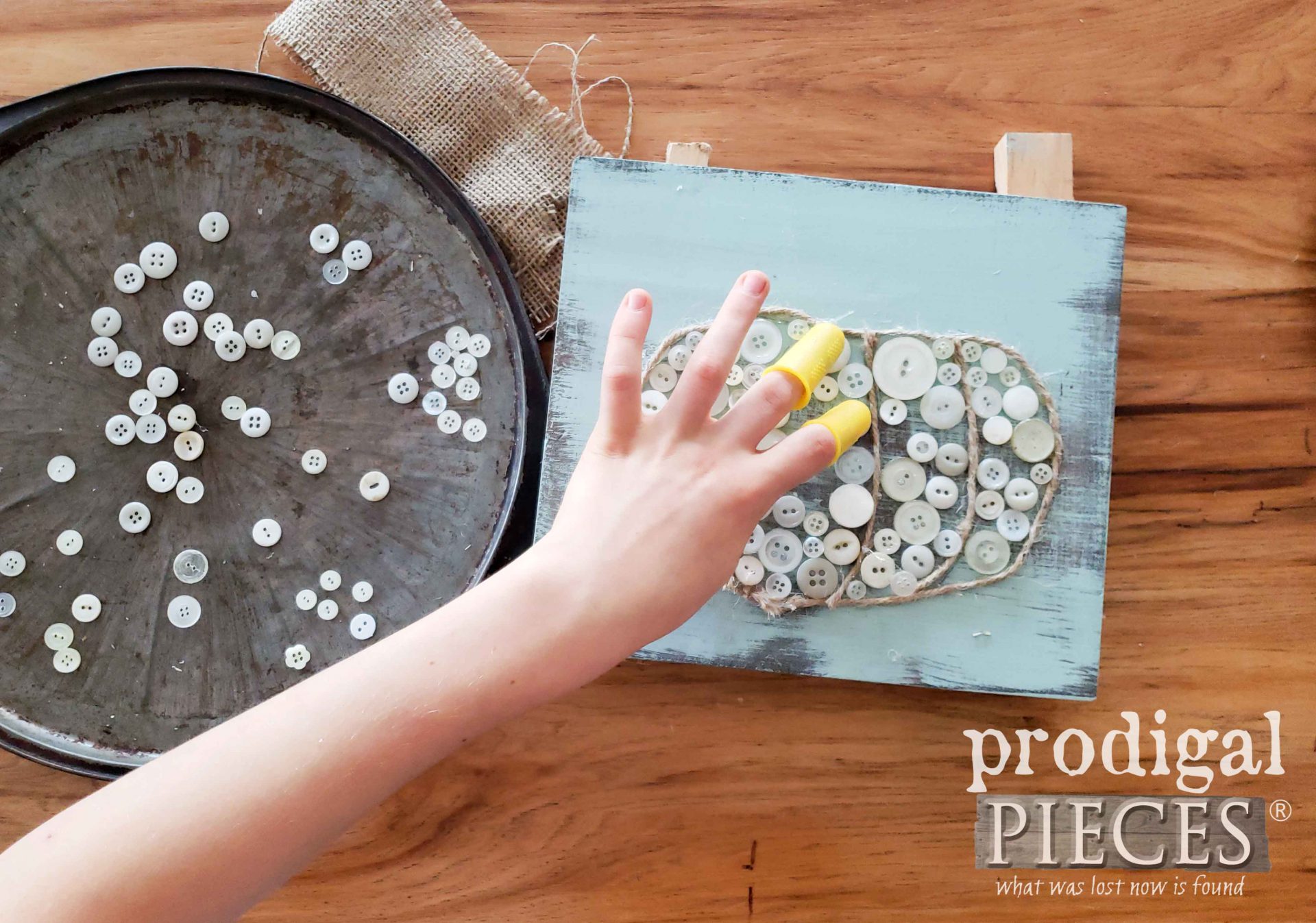 Gluing on Buttons to Fall Pumpkin Button Art by Prodigal Pieces Kids CREATE | prodigalpieces.com
