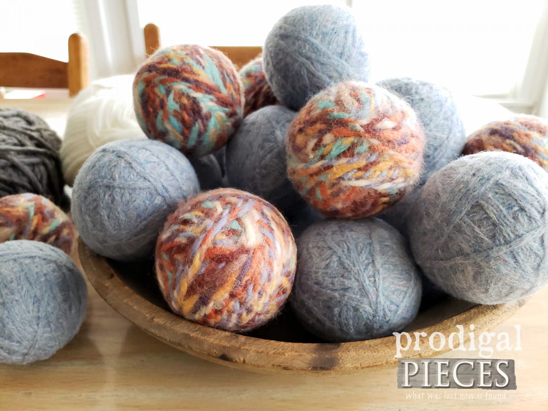 Bowl of Handmade Wool Dryer Balls by Larissa of Prodigal Pieces | prodigalpieces.com #prodigalpieces #diy #wool #yarn #crafts #laundry #farmhouse