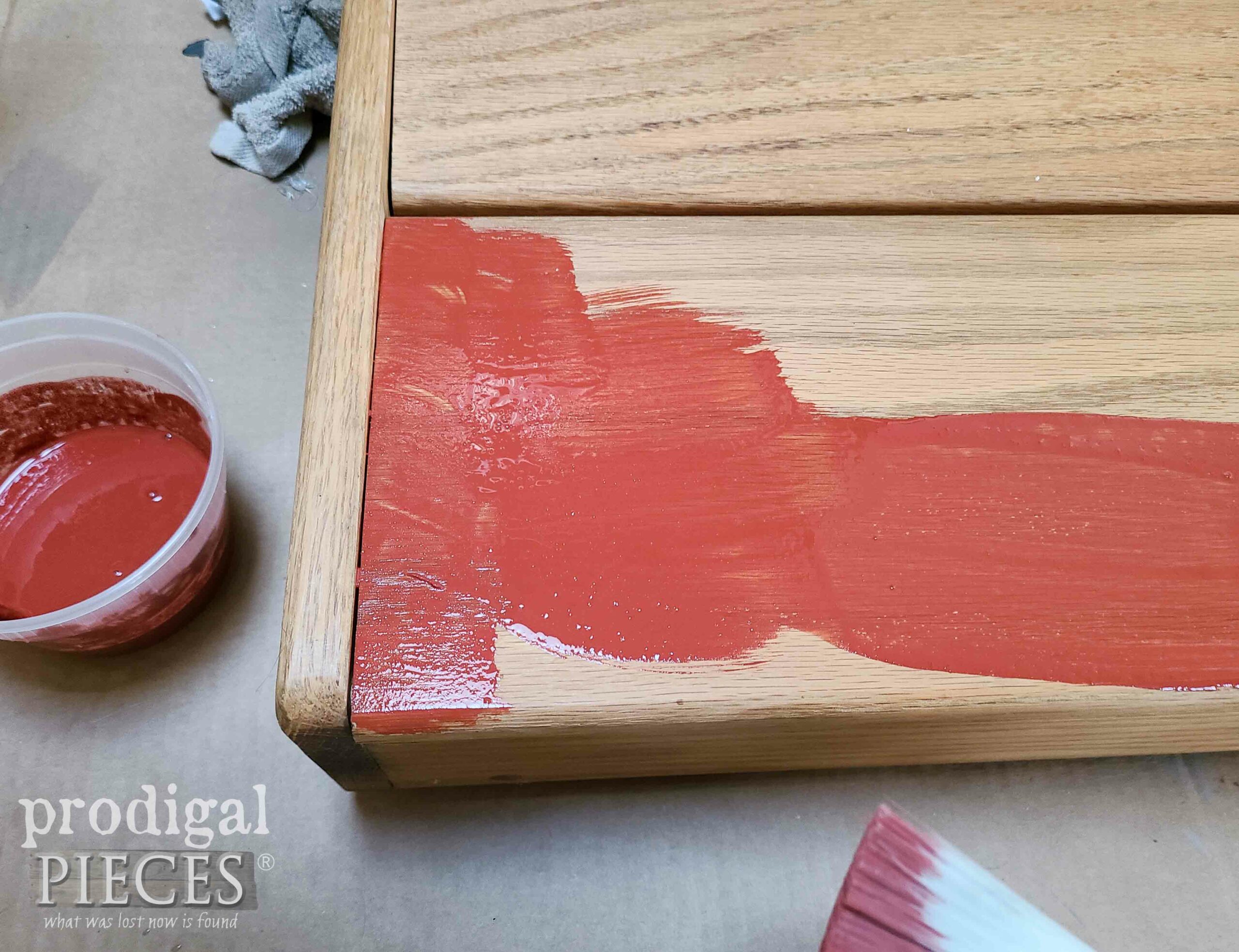Painting Red Milk Paint on DIY Ironing Board Cabinet | prodigalpieces.com #prodigalpieces
